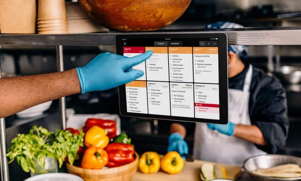 Kitchen staff using an Oracle Kitchen Display System during service